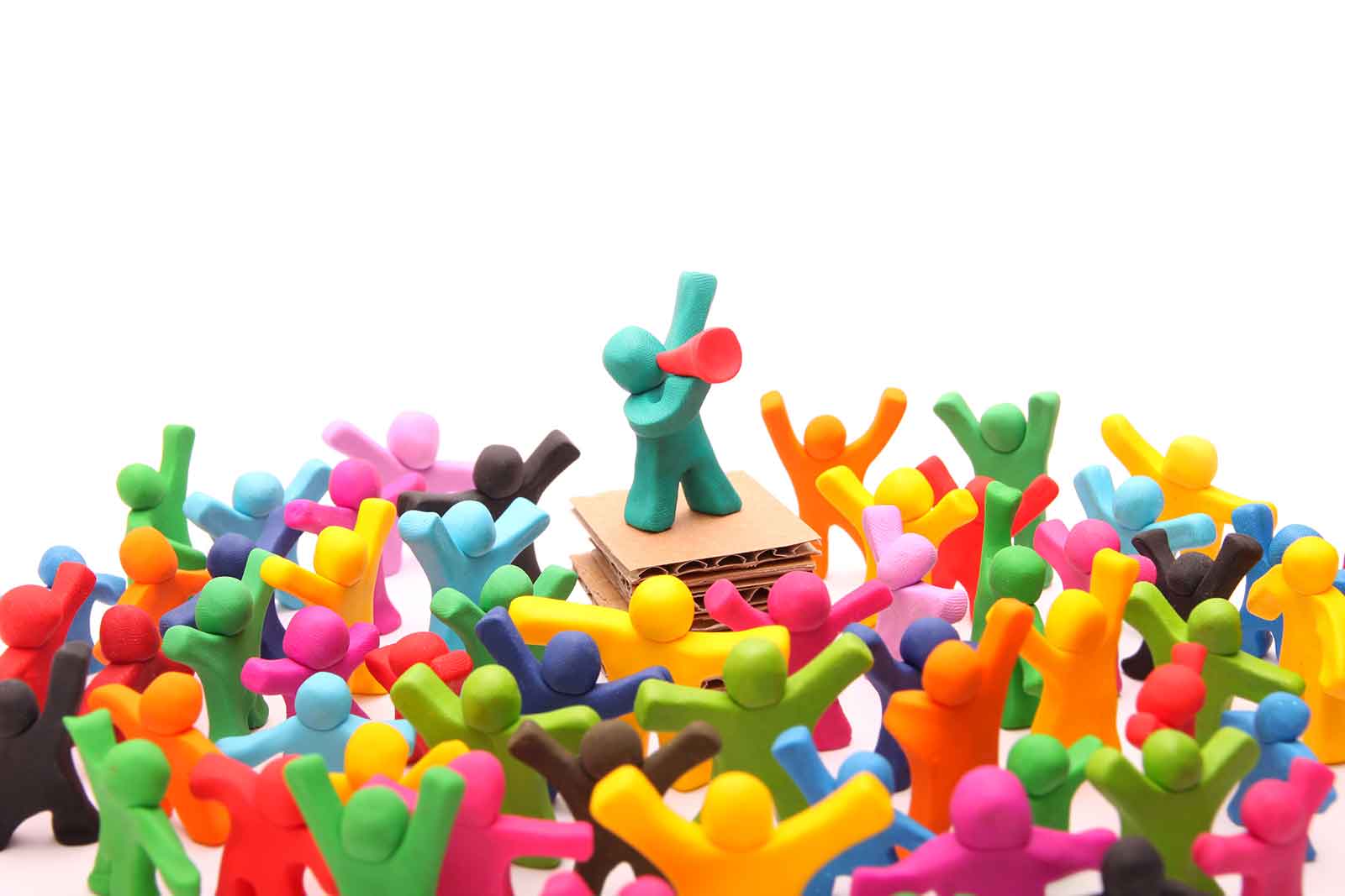 A group of gumby-like plastic figures stand around listening to another gumby-like figure talking through a megaphone. This is symbolising branded content and brand journalism. Hey, it's not an easy subject to find a good image for!