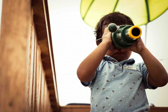 Email newsletter tips for marketers, child playing with toy representing curiosity