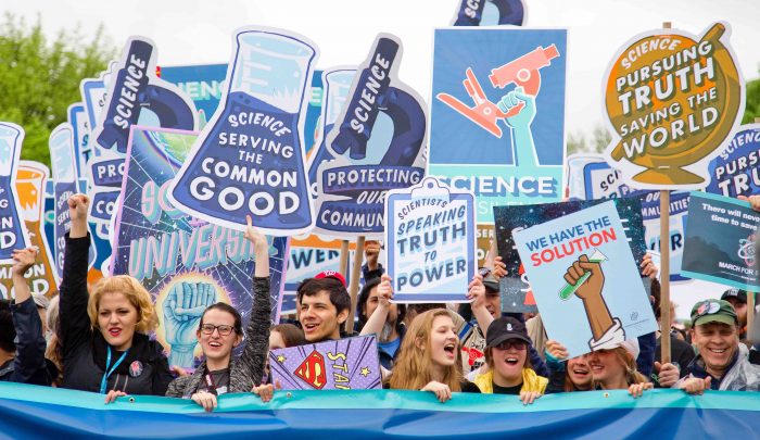 People on a pro-science march, symbolising the importance of the science to the success of a content marketing strategy.