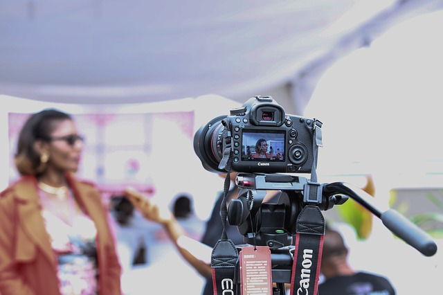 A woman in front of a camera, symbolsing being covered in traditional media.