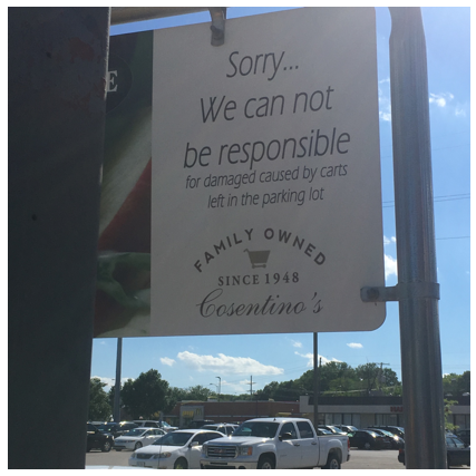 Sign says "Sorry... we can not be responsible for damaged caused by carts left in the parking lot"