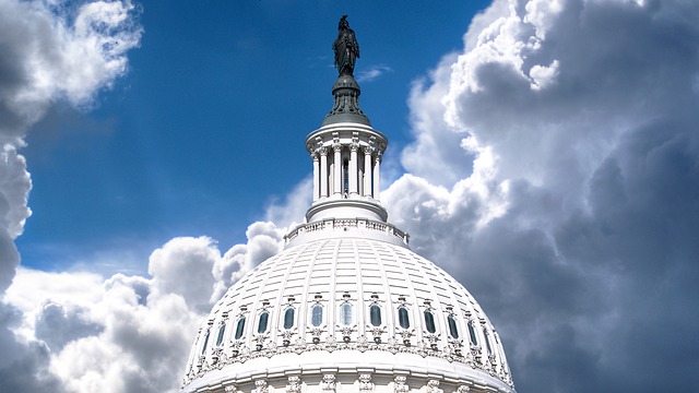 The US Capitol Building with dark clouds overhead.
