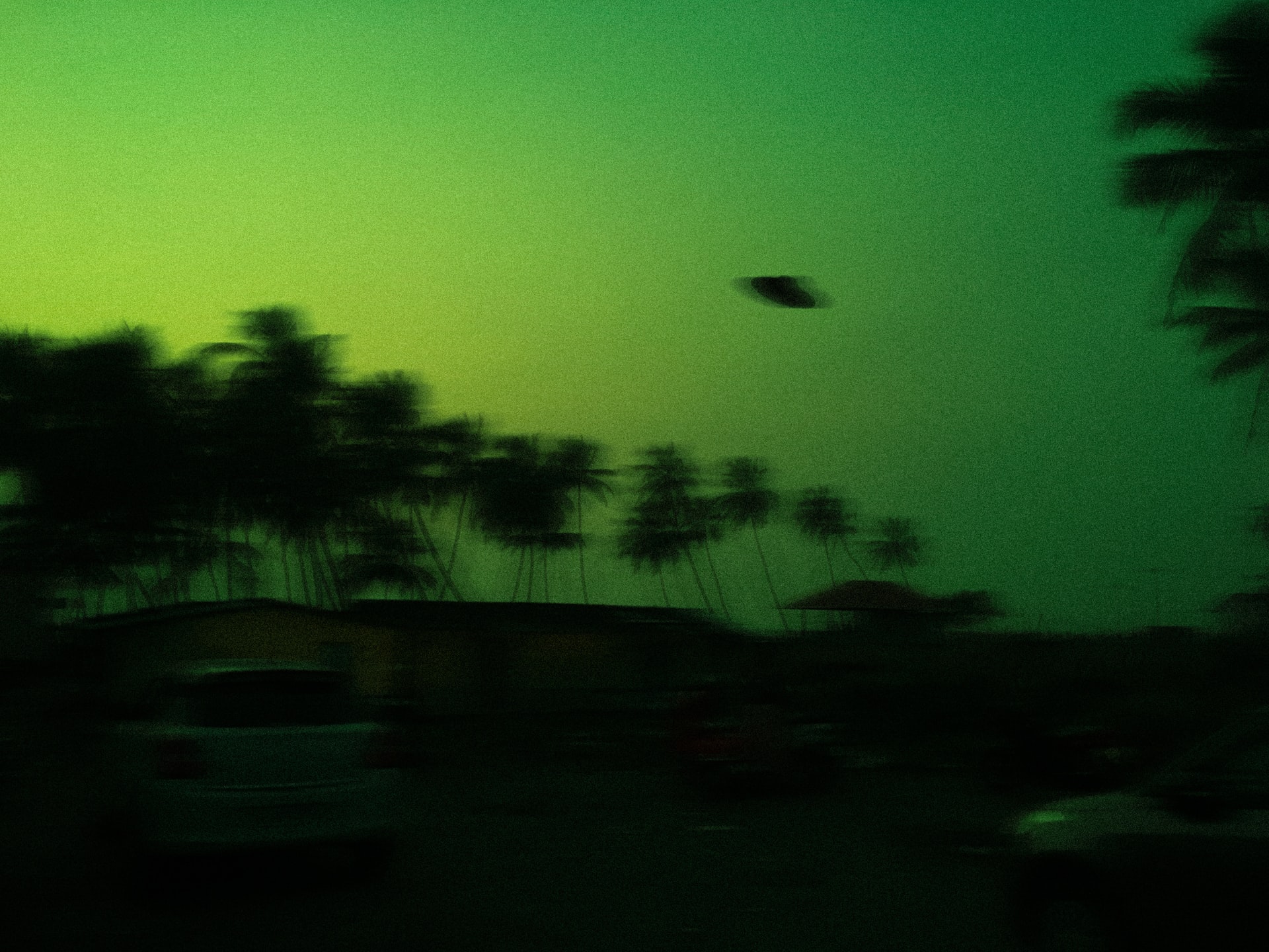 A flying saucer in a green sky