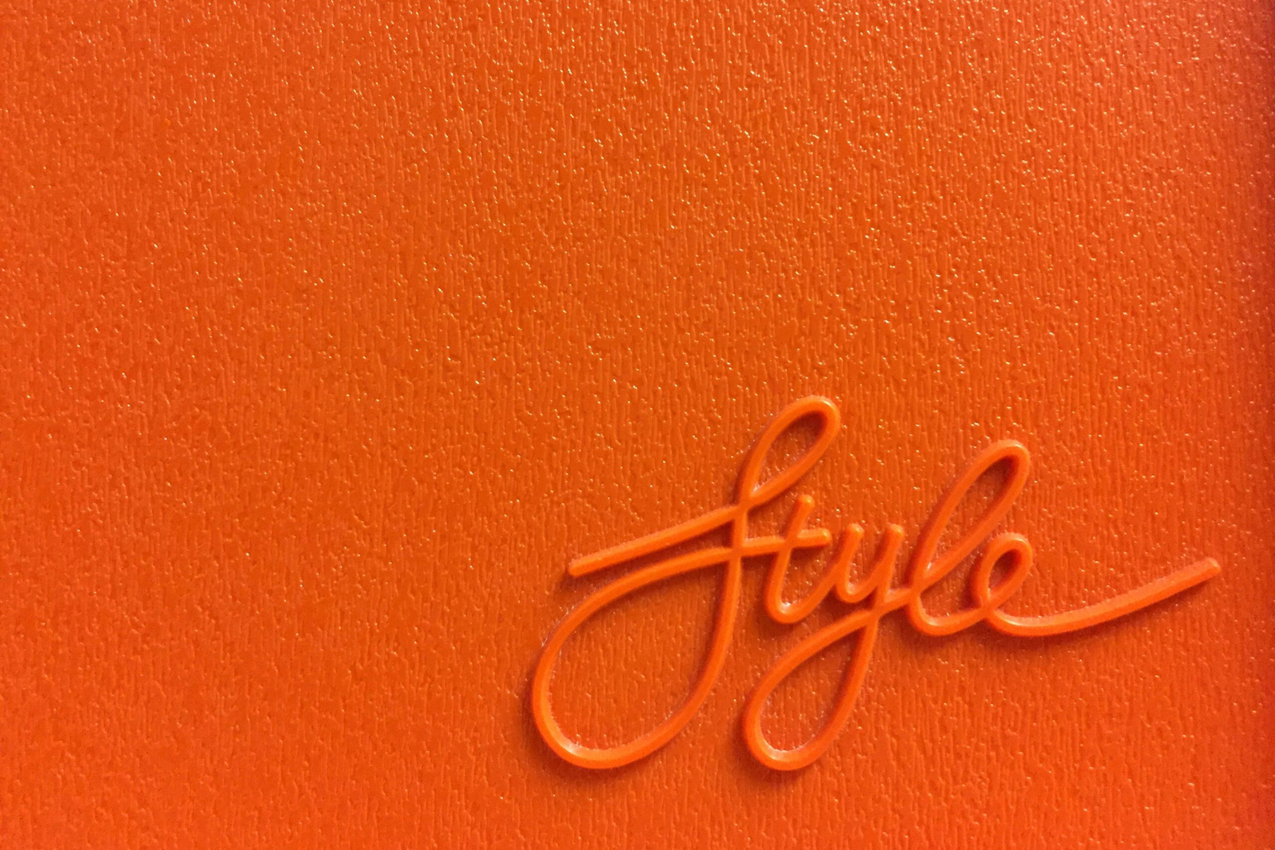 An orange surface with "style" written on it in a script font.
